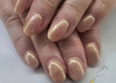 Glittering gold nails at Melonie's Nail Salon in Hastings, England, GB showcase expert artistry and design.