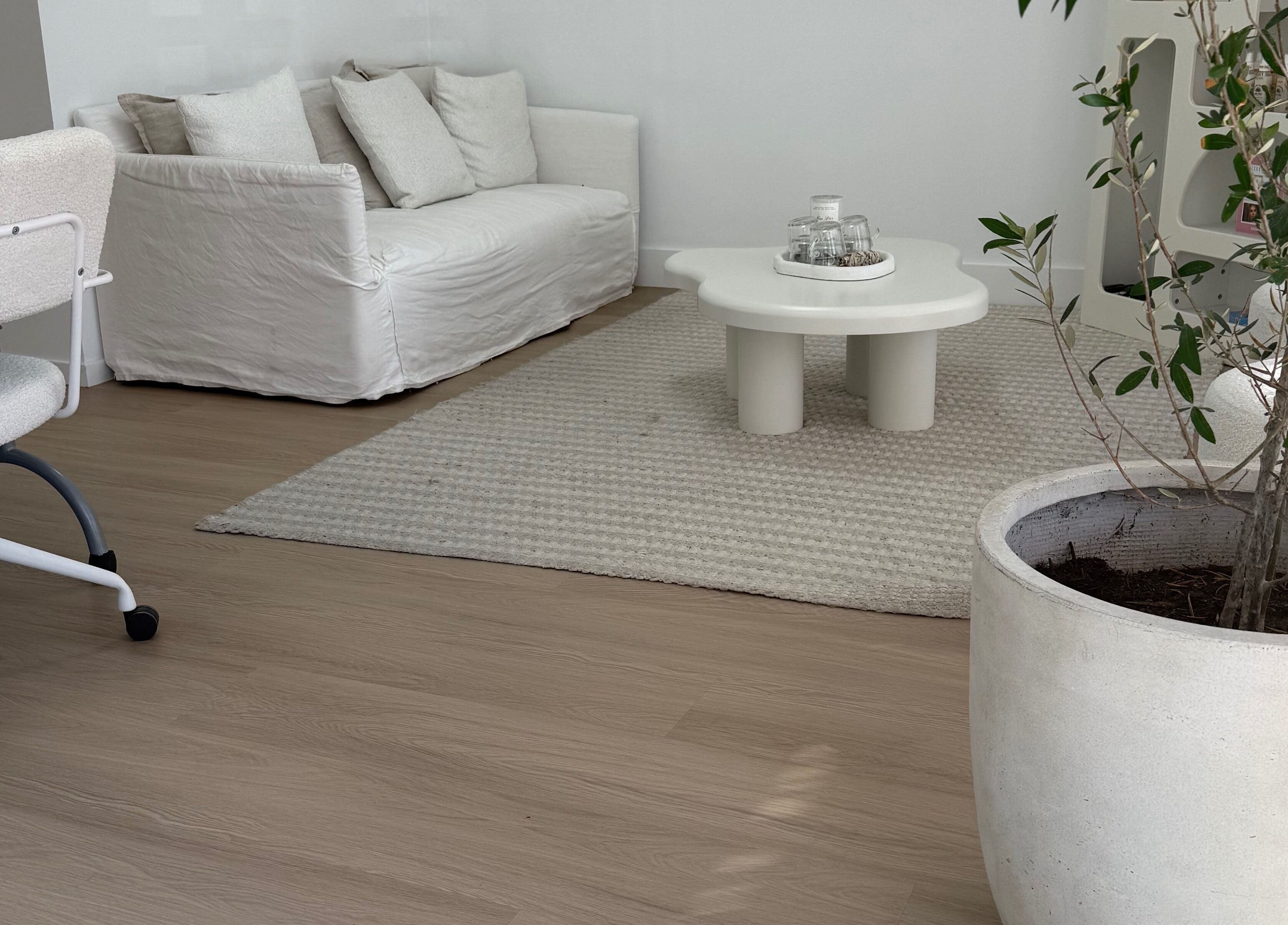 Elegant lounge area with white sofa at The House of Lashes Beauty Bar, Robina, Queensland, AU.