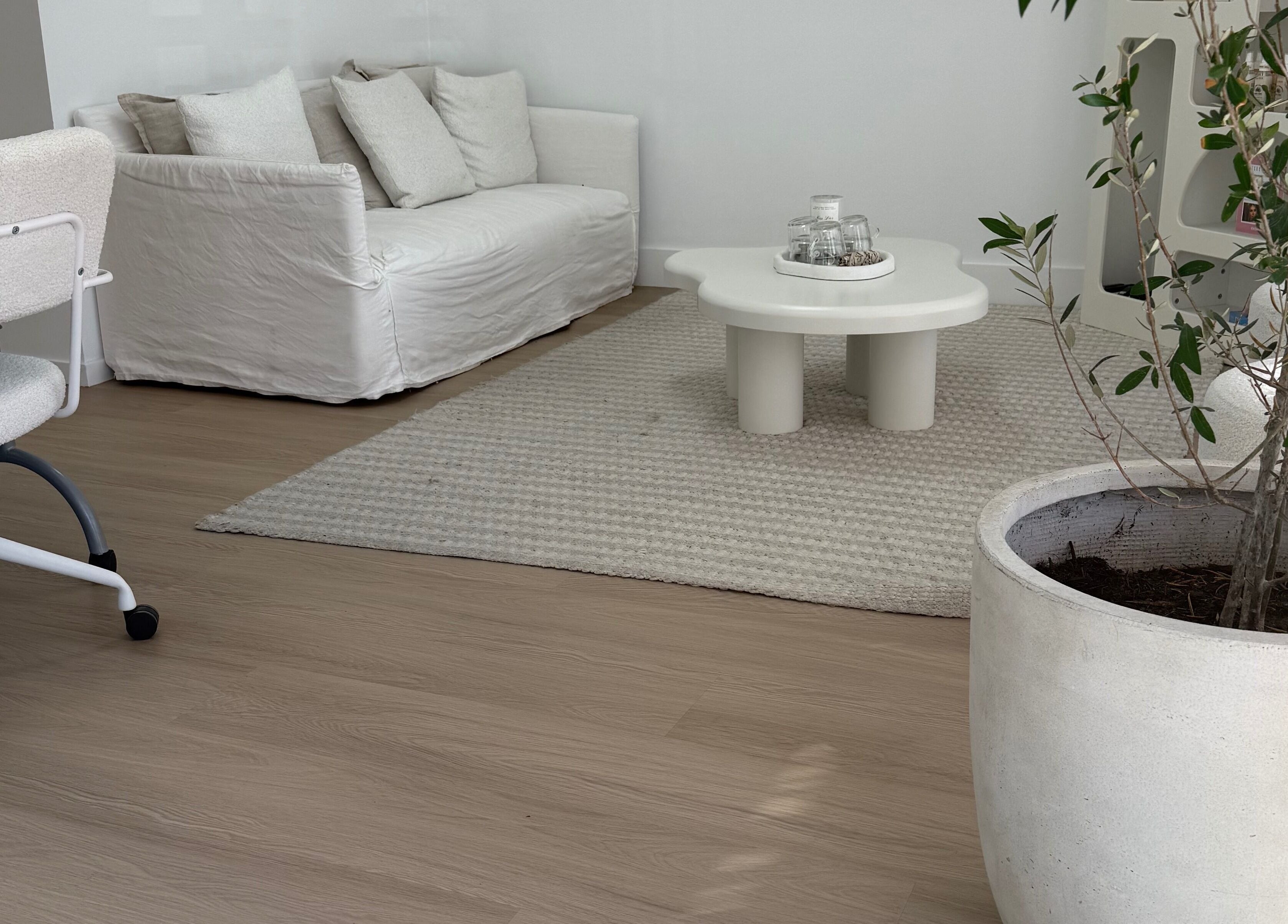 Elegant lounge area with white sofa at The House of Lashes Beauty Bar, Robina, Queensland, AU.