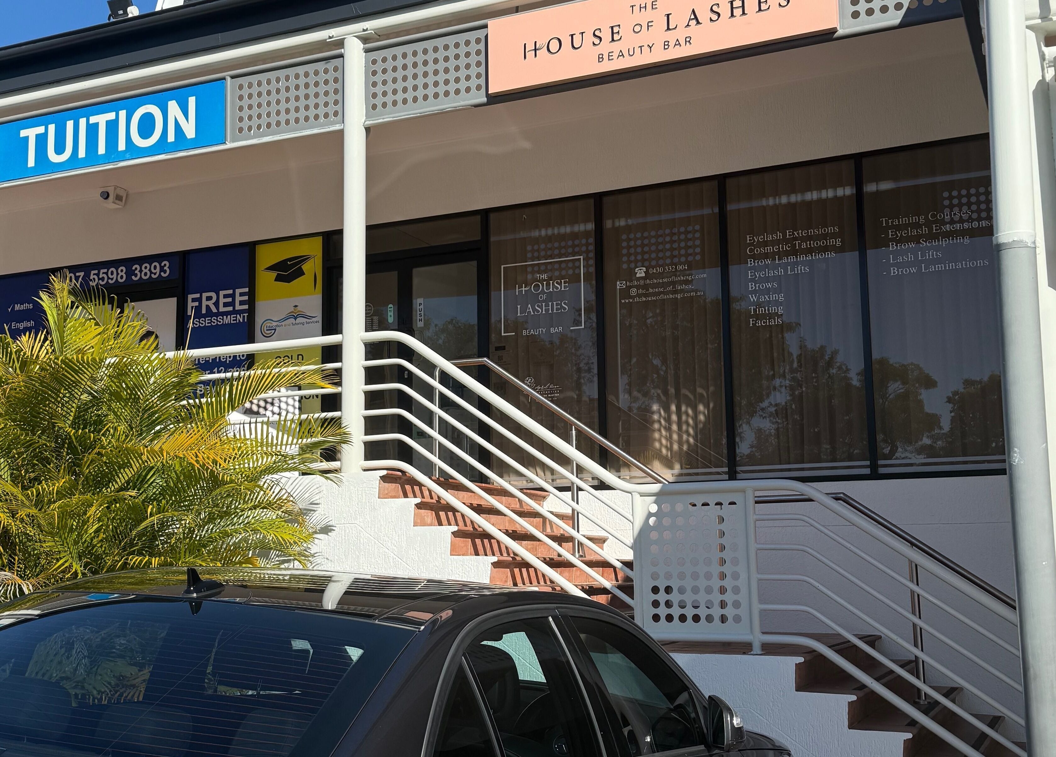 Entrance to The House of Lashes Beauty Bar in Robina, Queensland, AU, highlighted with signage and greenery.