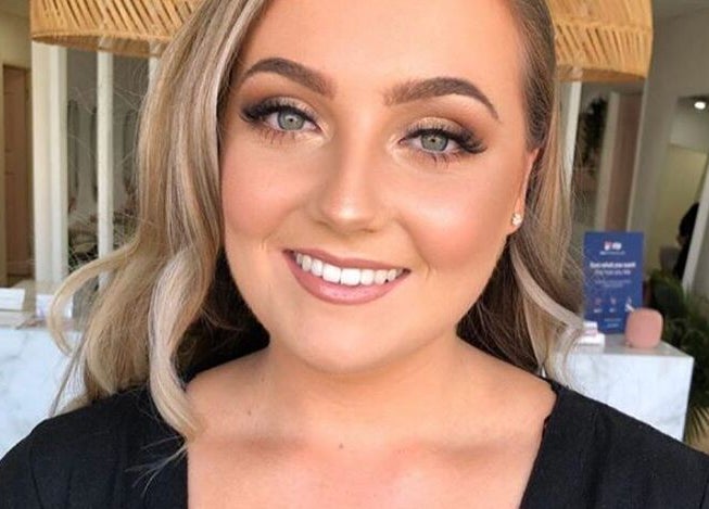 Smiling woman with makeup at The House of Lashes Beauty Bar, Robina, Queensland, AU.