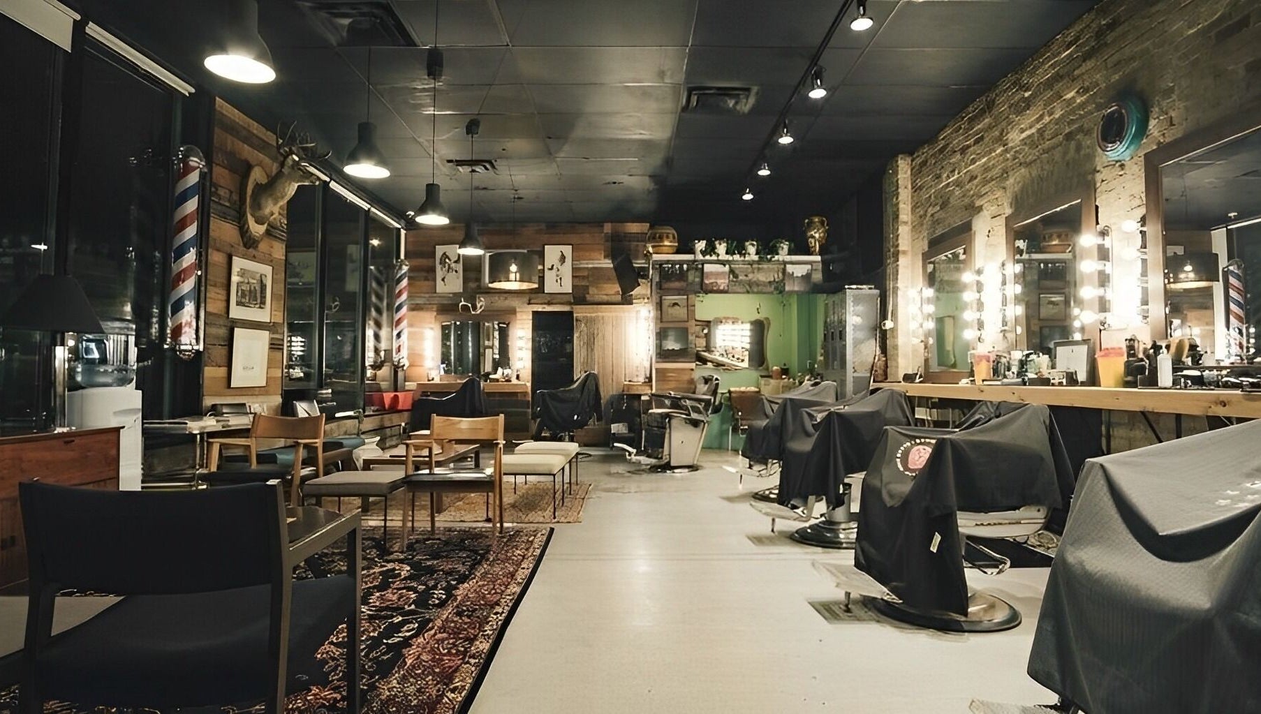 Cozy interior of The Loving Barbers Company in Winnipeg, Manitoba, CA featuring stylish rustic decor and barber chairs.
