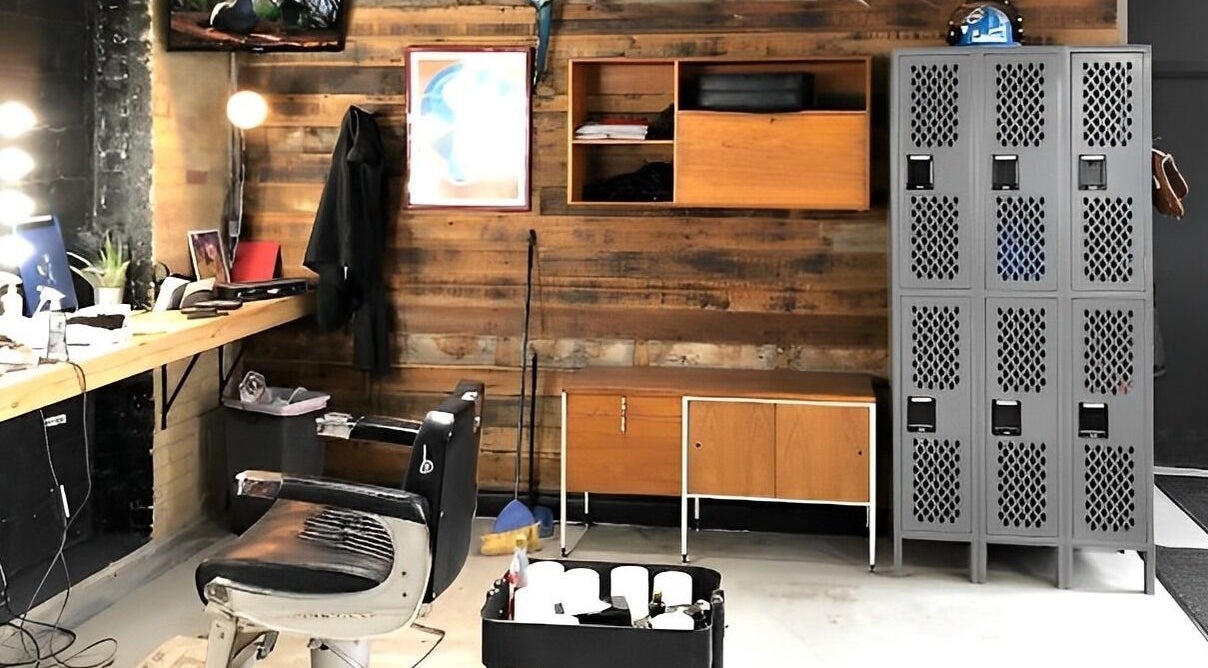 Chic barber station of The Loving Barbers Company in Winnipeg, Manitoba, CA with vintage chair and wood paneling.