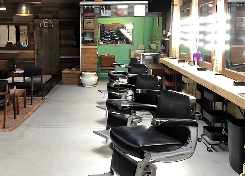 Barber chairs and mirrors at The Loving Barbers Company in Winnipeg, Manitoba, CA, showcasing modern style.