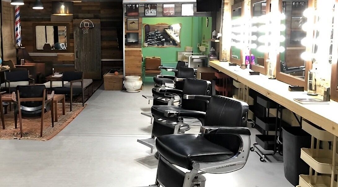 Barber chairs and mirrors at The Loving Barbers Company in Winnipeg, Manitoba, CA, showcasing modern style.