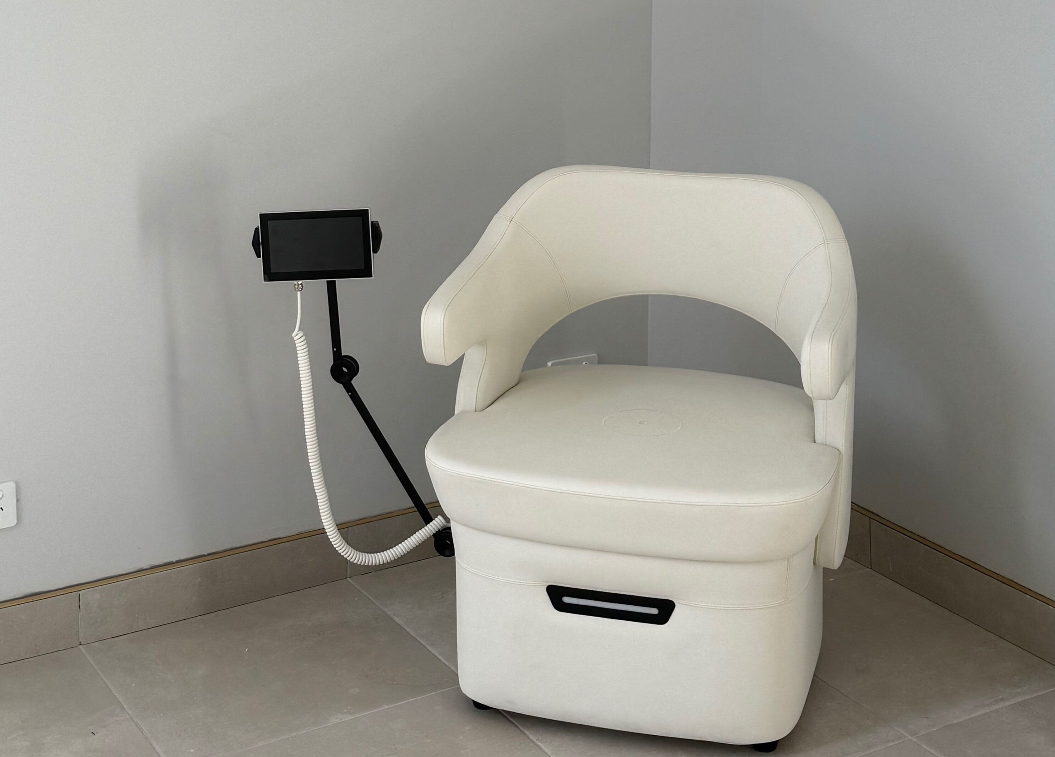 White spa chair with tablet stand at Studio Skinthetics, Kalkallo, Victoria, AU.
