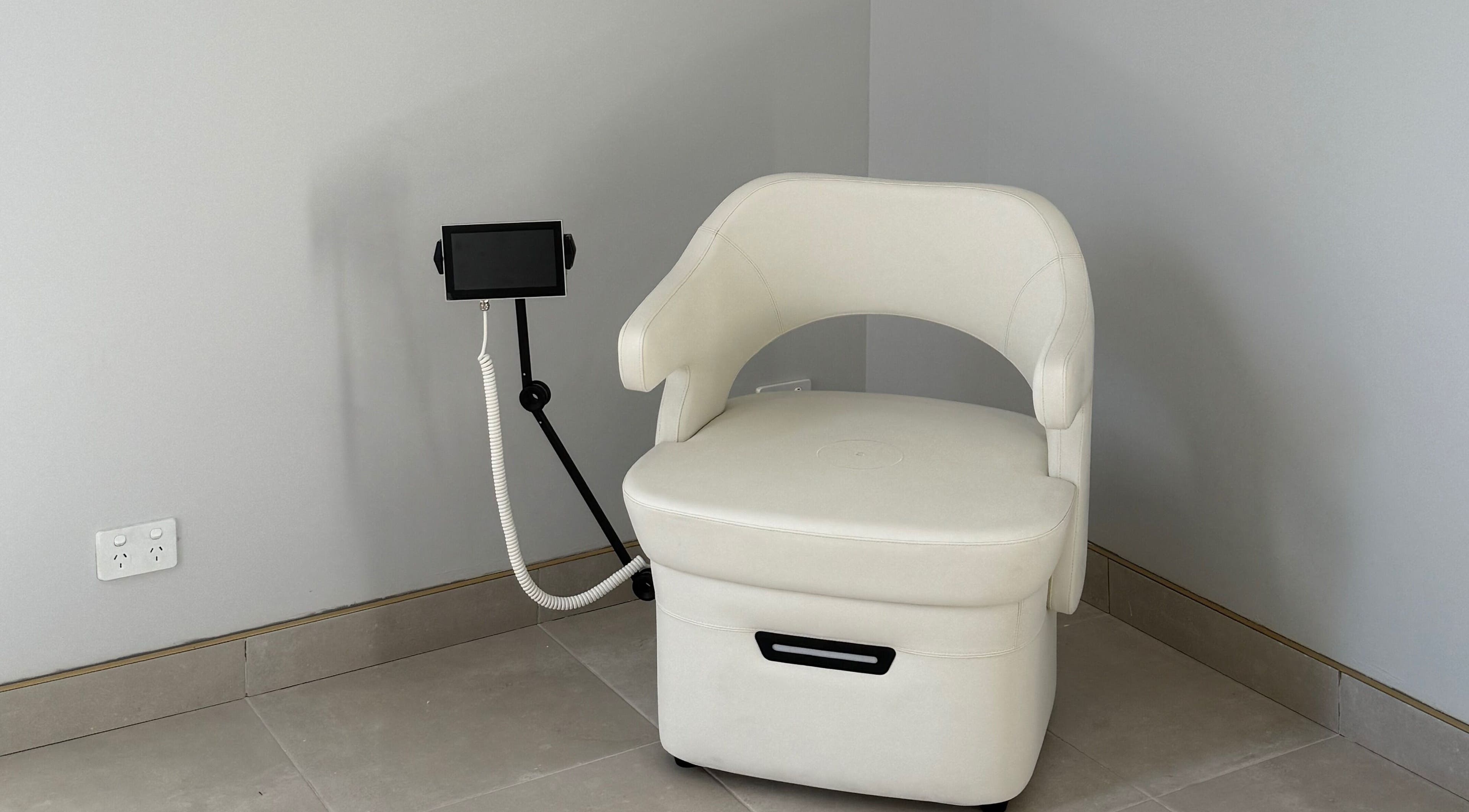 White spa chair with tablet stand at Studio Skinthetics, Kalkallo, Victoria, AU.