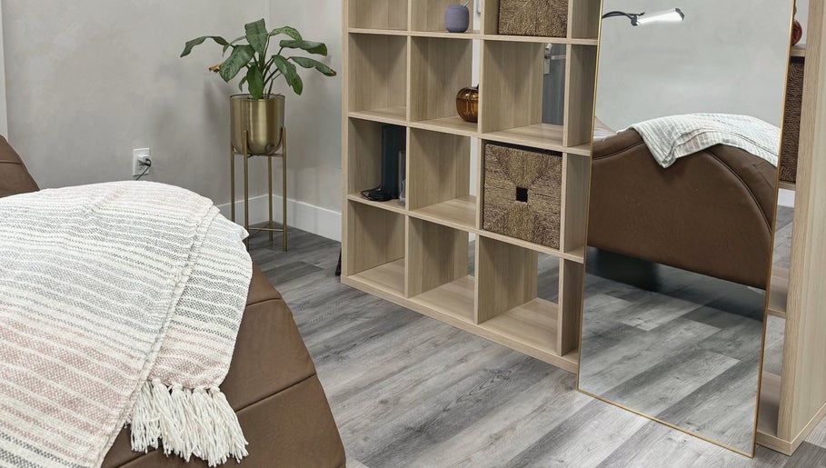 Cozy therapy room at THE LAB with a massage bed and plant decor in Miami, Florida, US.