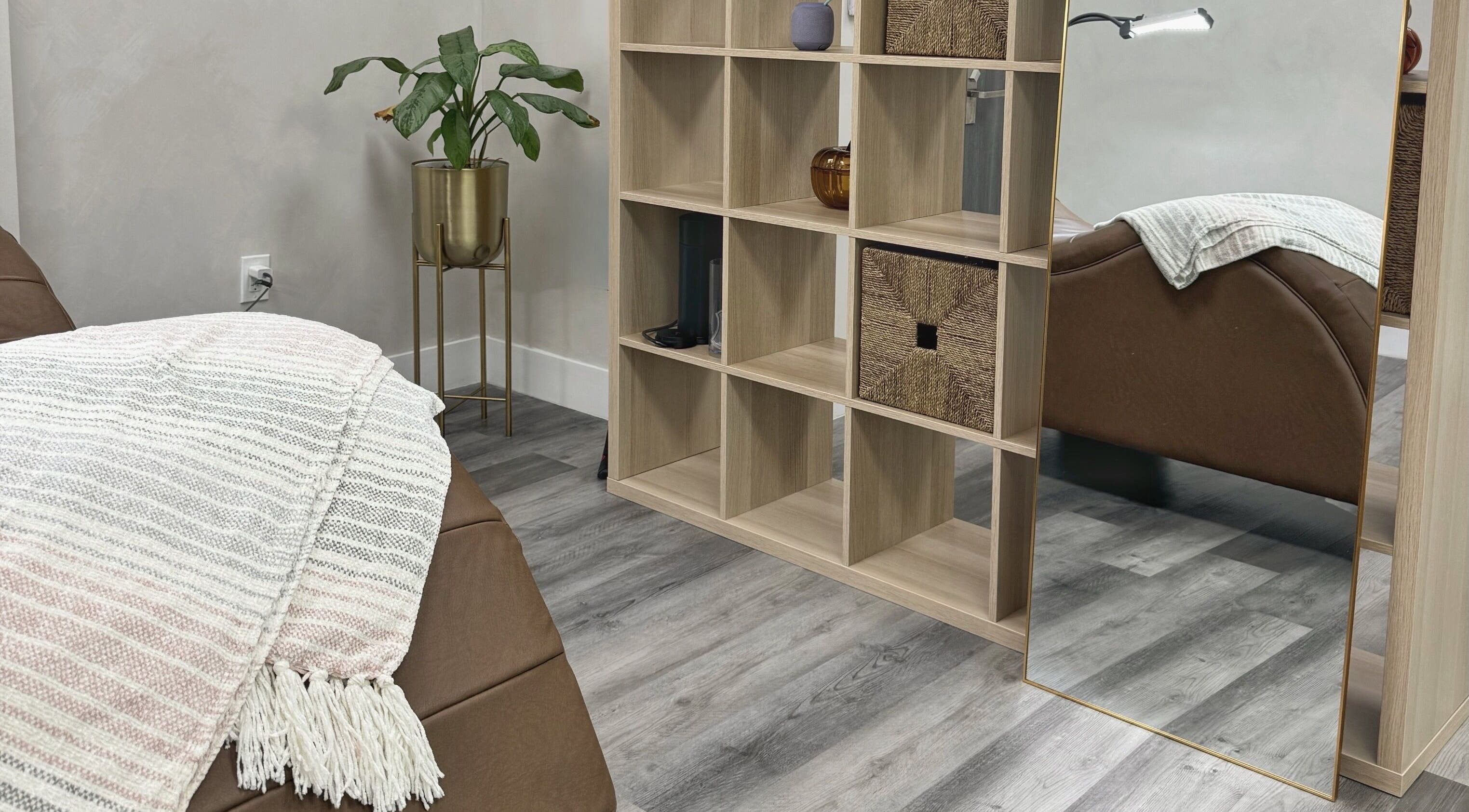 Cozy therapy room at THE LAB with a massage bed and plant decor in Miami, Florida, US.