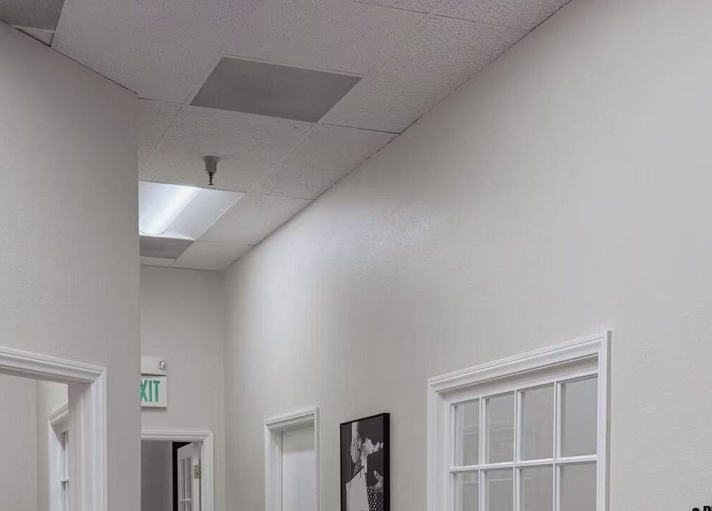 Interior hallway at Queena Lash - Upland in Upland, California, US, featuring elegant white walls and modern decor.