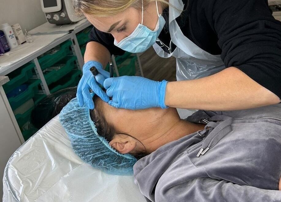 Aesthetician performing brow treatment at BrowHouse, Hollingwood, England, GB salon.