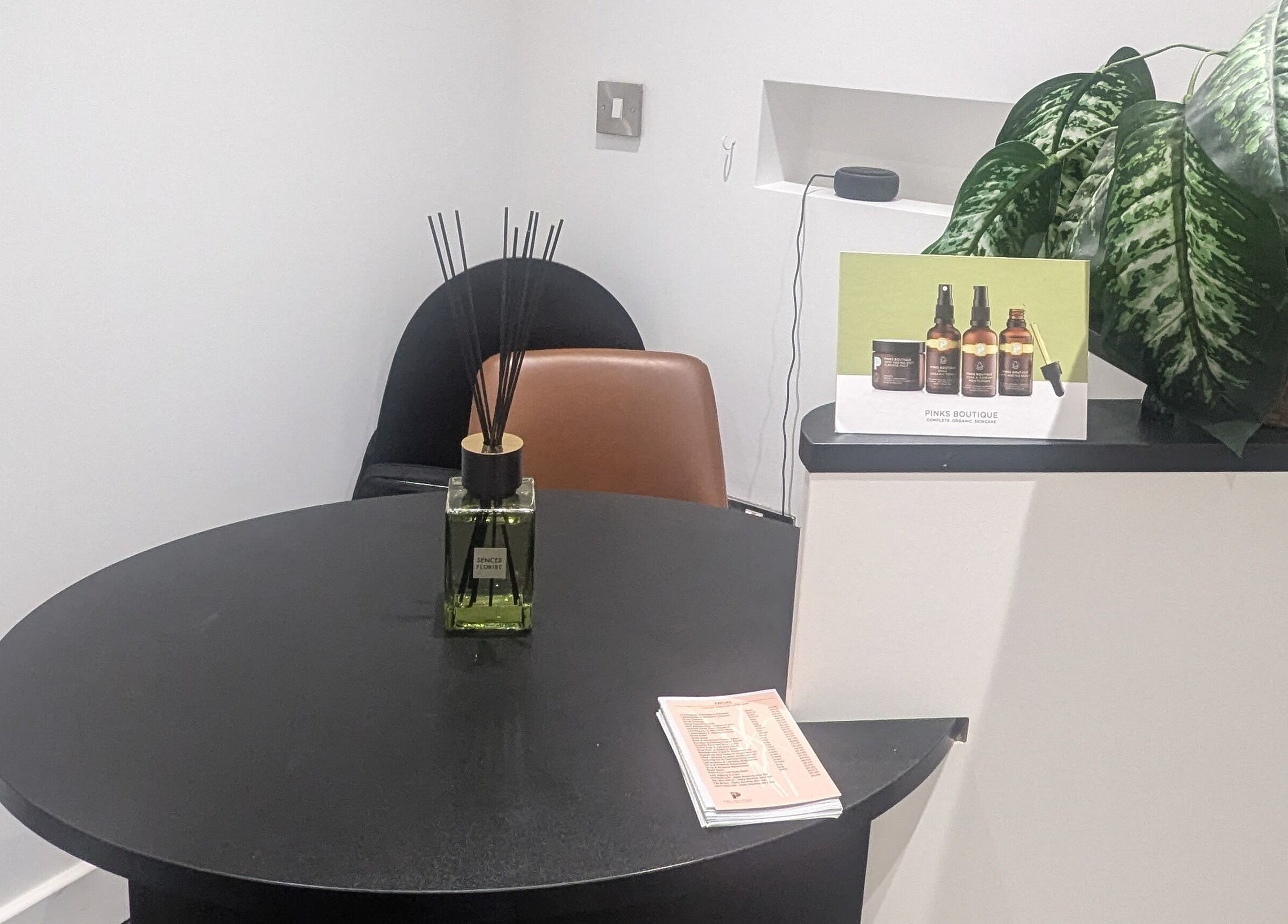 Relaxing corner at BrowHouse, Hollingwood, England, GB featuring a table, chair, and lush plant decor.