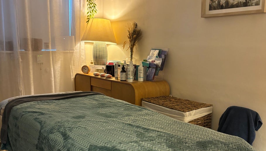 Cozy treatment room at A Blissful Balance, Wellesbourne, England, GB. Features a calming atmosphere and wellness products.