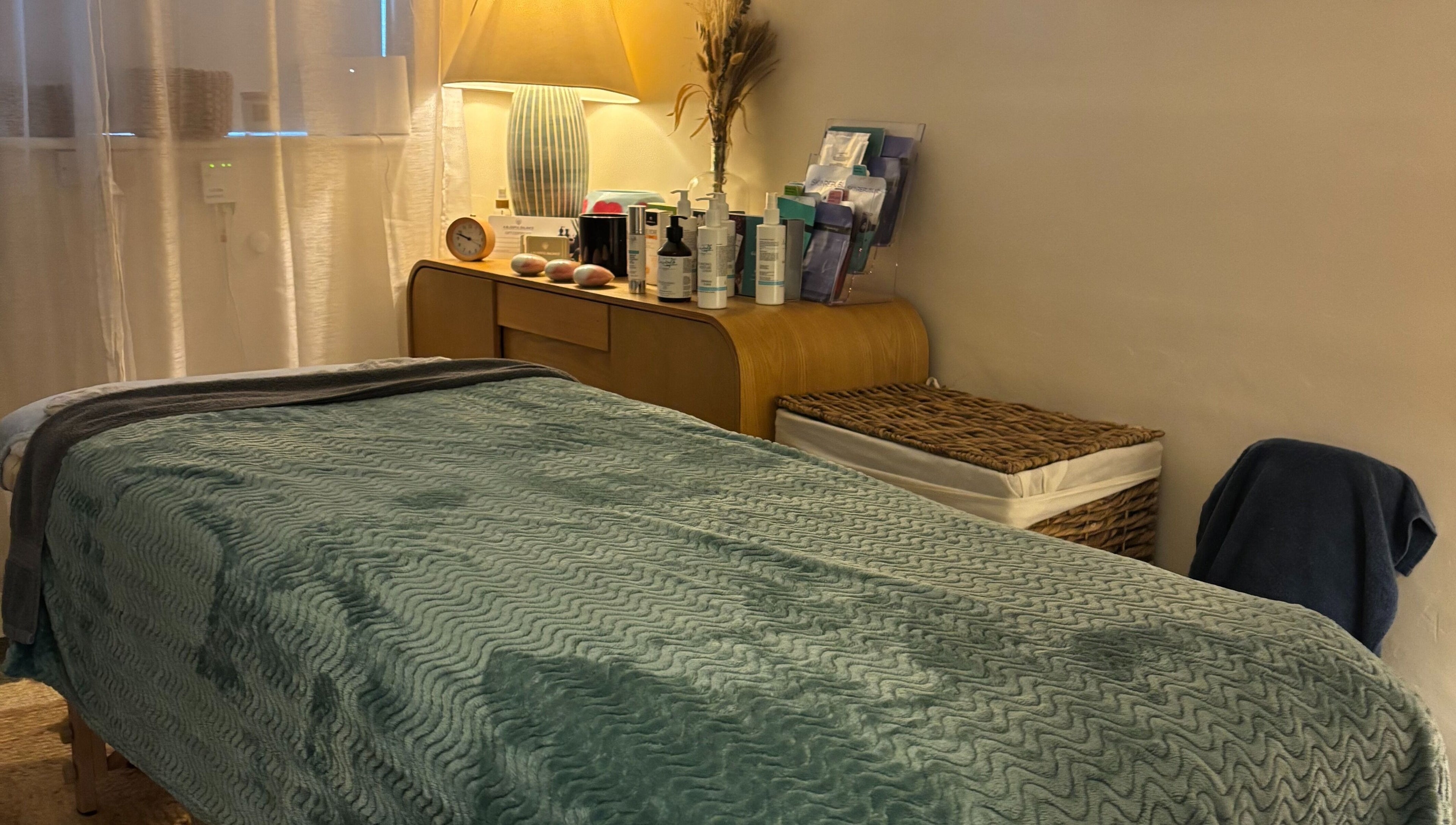 Peaceful spa room at A Blissful Balance, Wellesbourne, England, GB, with massage table and warm lighting.