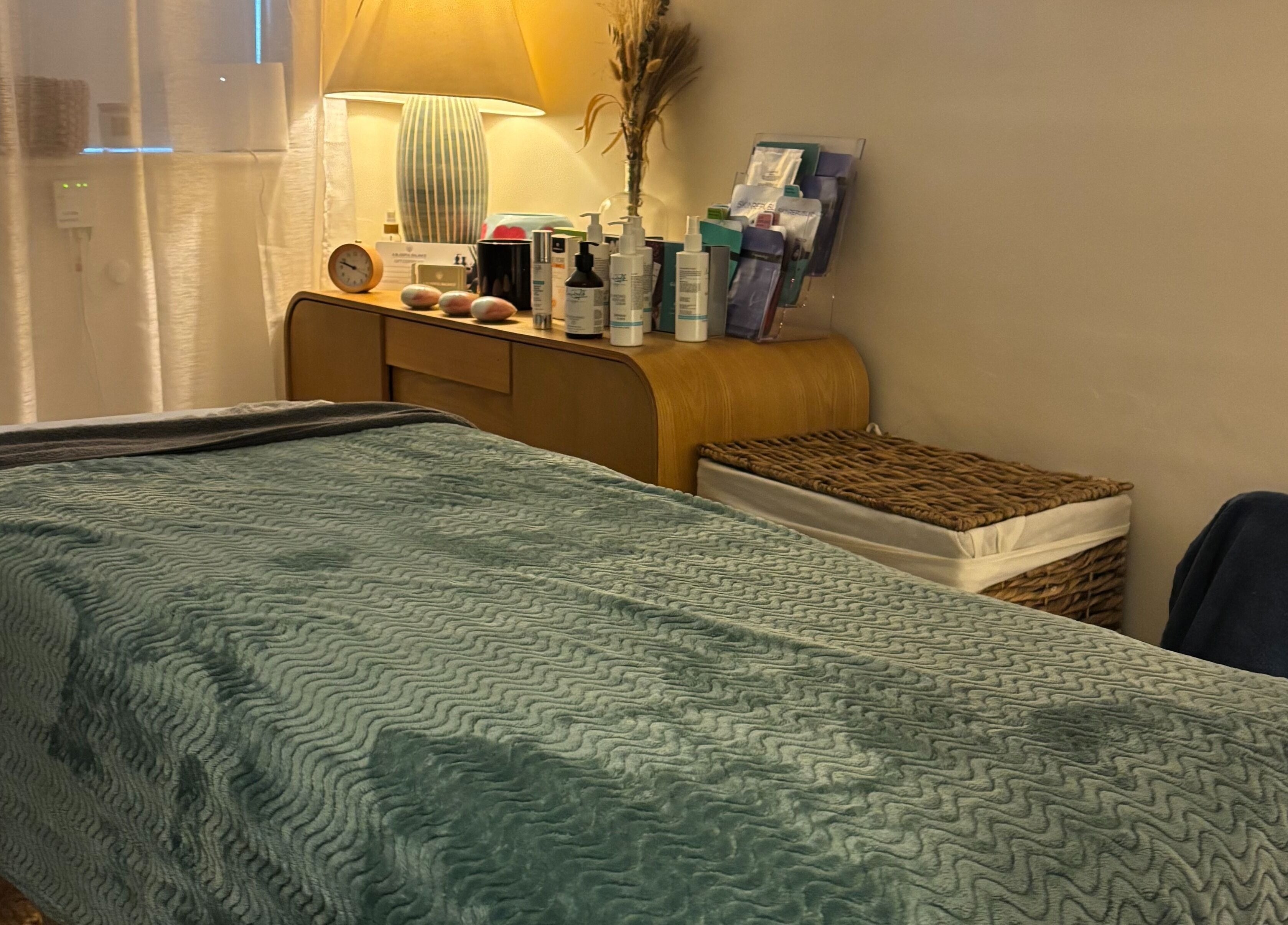 Peaceful spa room at A Blissful Balance, Wellesbourne, England, GB, with massage table and warm lighting.