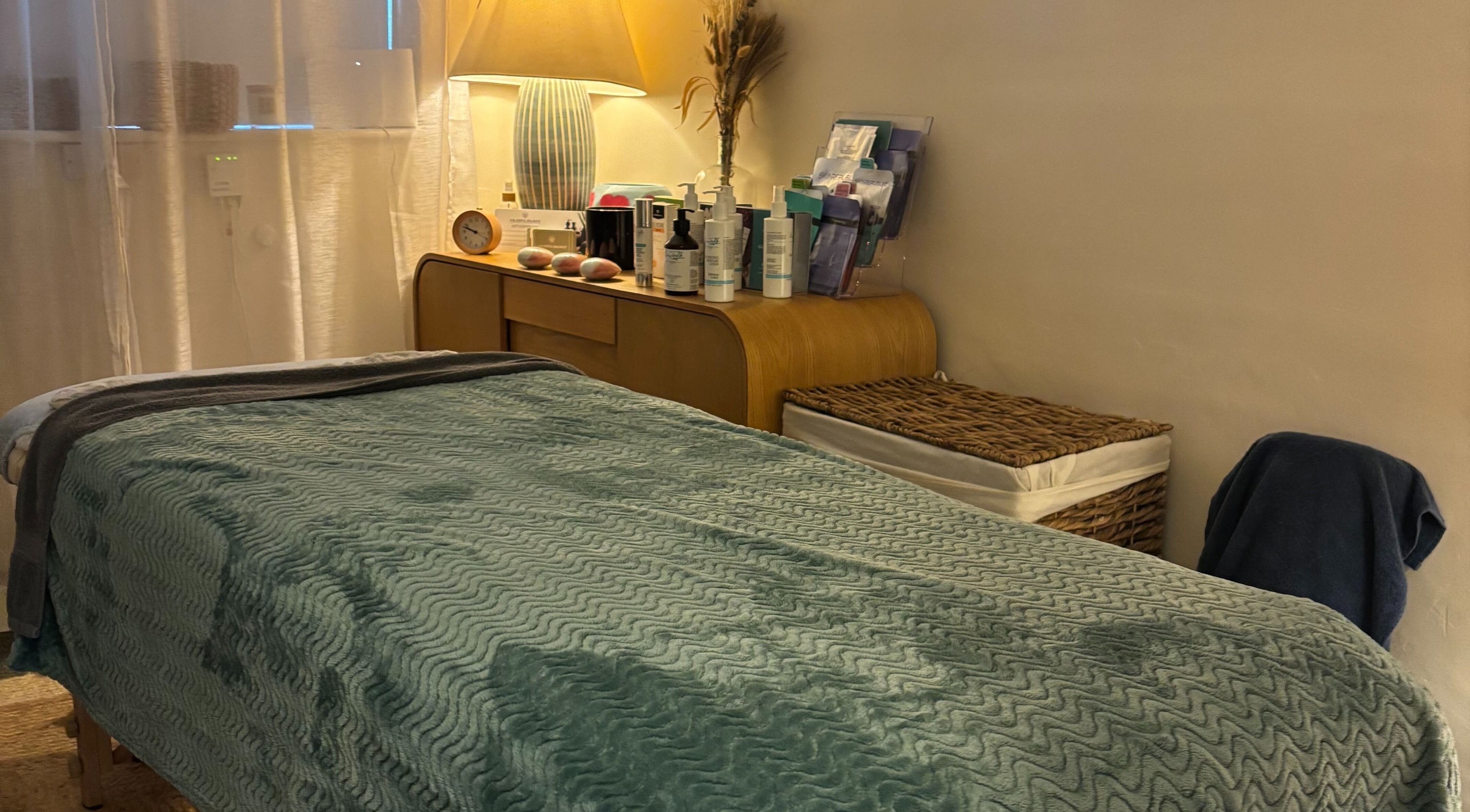 Peaceful spa room at A Blissful Balance, Wellesbourne, England, GB, with massage table and warm lighting.