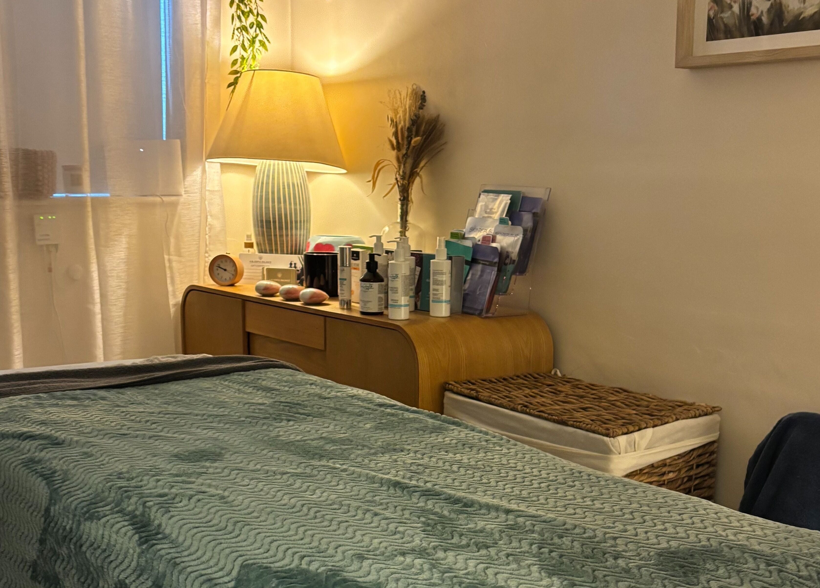 Serene treatment room at A Blissful Balance, Wellesbourne, England, GB with a cozy bed and soft lighting.