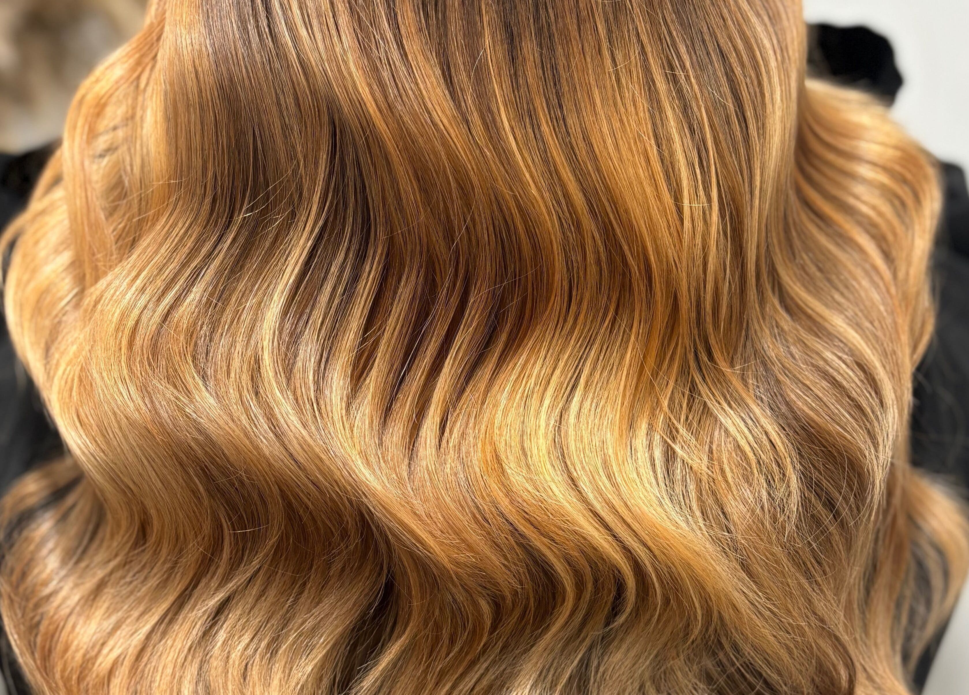 Elegant golden wavy hair styled at Hair by Sian Charlton in Cardiff, Wales, GB.
