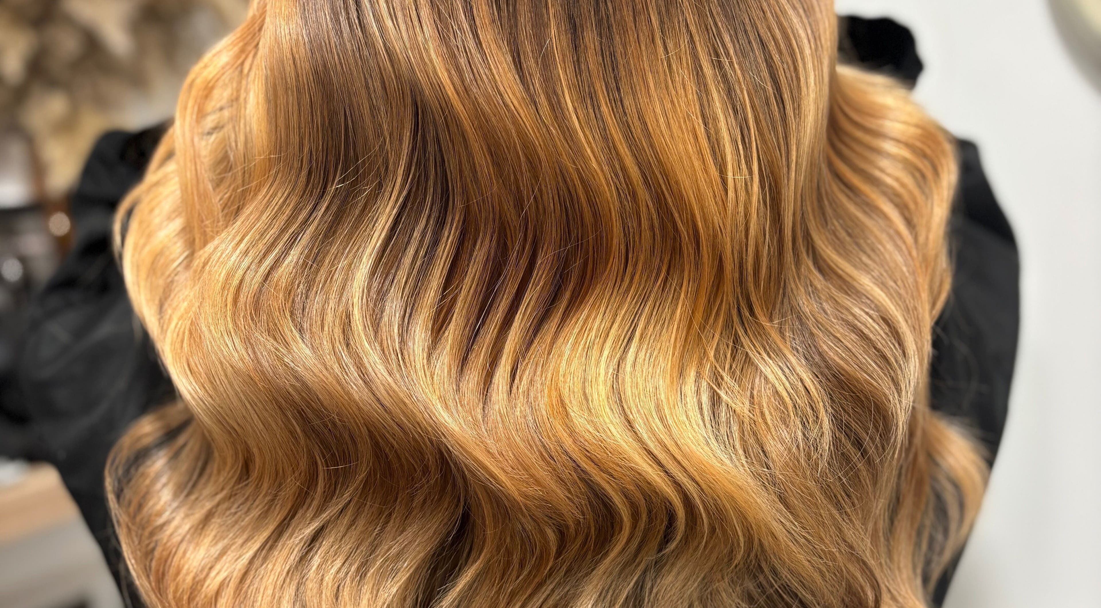 Elegant golden wavy hair styled at Hair by Sian Charlton in Cardiff, Wales, GB.