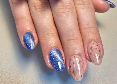 Dazzling blue glitter nails and starry accents at Alyss Marie Beauty, Wombwell, England, GB.