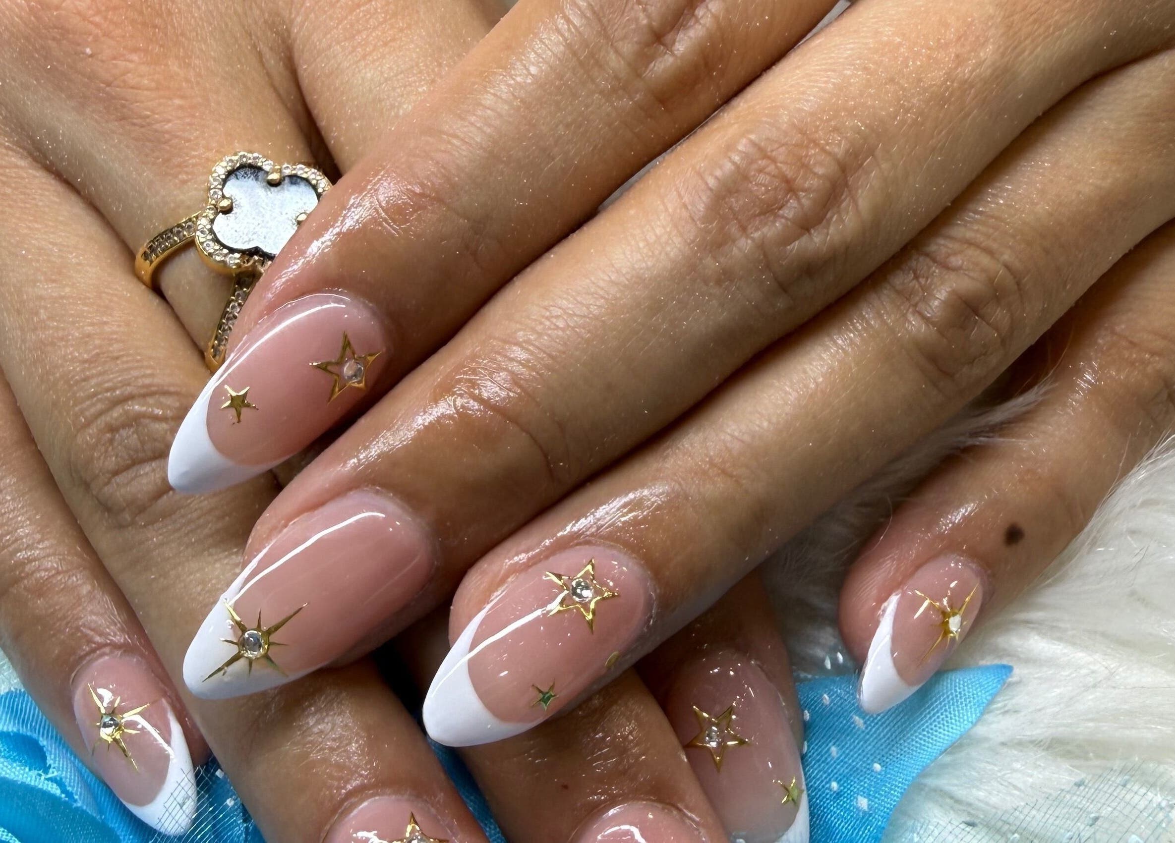 Elegant French manicure with star designs at Langley Park Nails (East Perth), East Perth, Western Australia, AU.