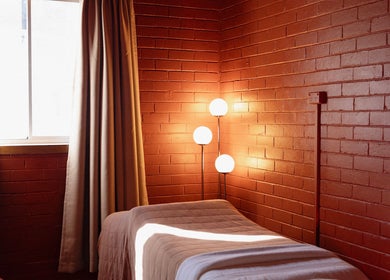 Cozy massage room at Just Massage, Diamond Creek, Victoria, AU with warm lighting and calming decor.