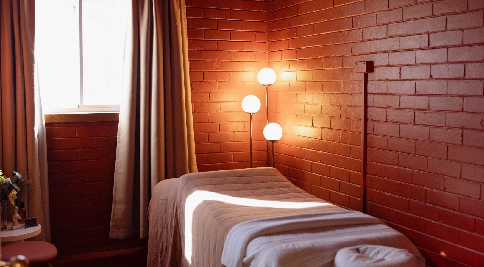 Tranquil massage room at Just Massage, Diamond Creek, Victoria, AU, featuring soft lighting and a cozy bed.
