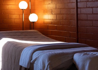 Serene massage room at Just Massage, Diamond Creek, Victoria, AU with warm lighting and comfortable table.