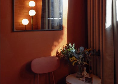 Warm, inviting corner at Just Massage, Diamond Creek, Victoria, AU. Features ambient lighting and floral decor.