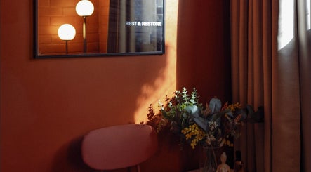 Warm, inviting corner at Just Massage, Diamond Creek, Victoria, AU. Features ambient lighting and floral decor.