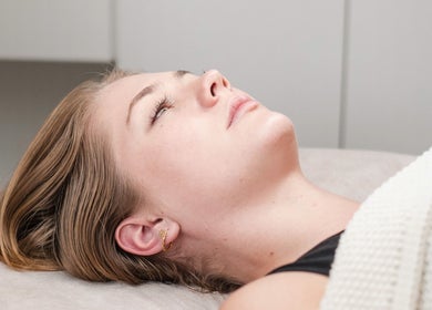 Relaxed woman receiving treatment at The Dermal Haven, Bentleigh East, Victoria, AU.