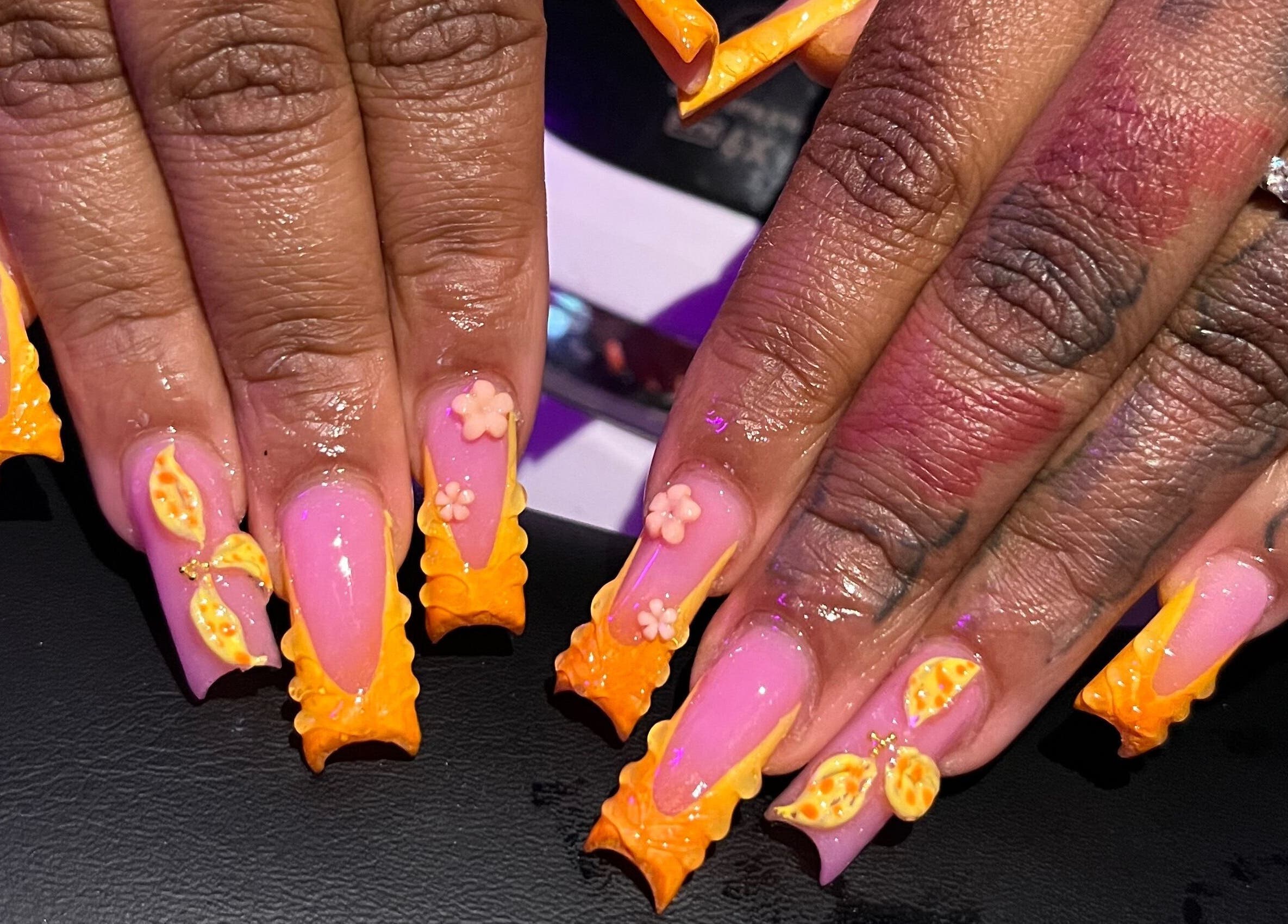 Detailed nail art with orange accents at Visage VERITAS, Troy, New York, US.