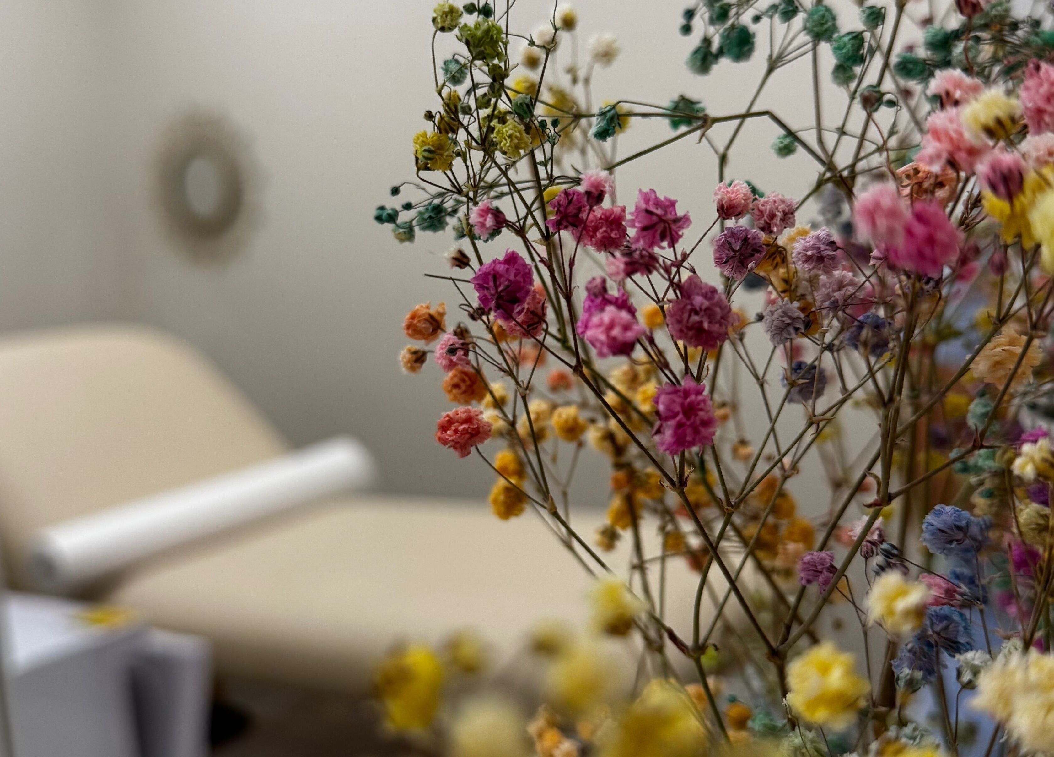 Cozy treatment room with vibrant flowers at Sugaring & Waxing by Ervina, Los Angeles, California, US.