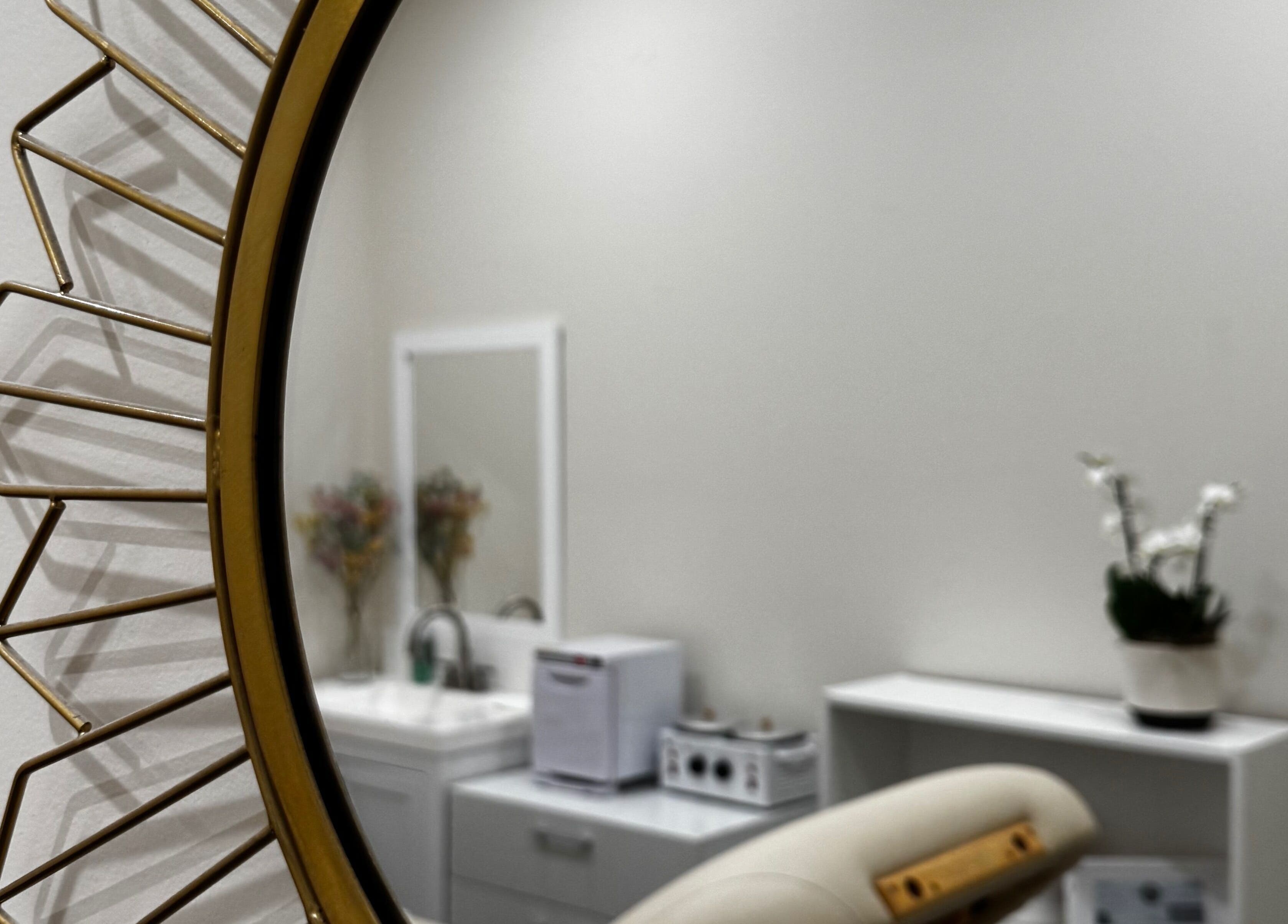Modern salon interior at Sugaring & Waxing by Ervina in Los Angeles, California, US with chic mirror and decor.