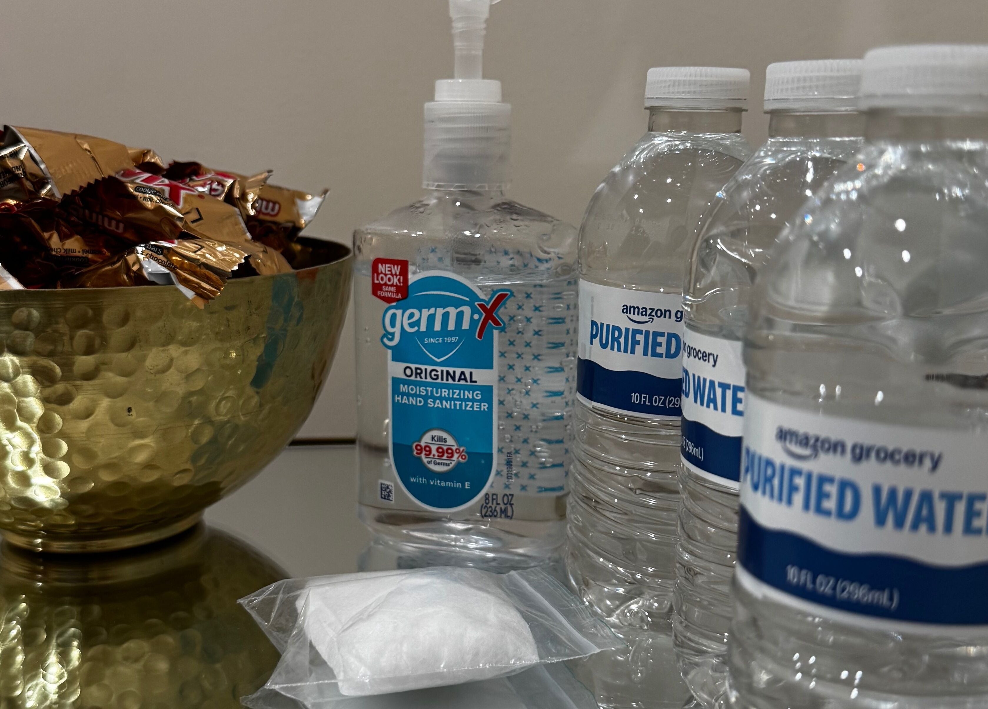 Refreshment station at Sugaring & Waxing by Ervina in Los Angeles, California, US with bottled water and snacks.