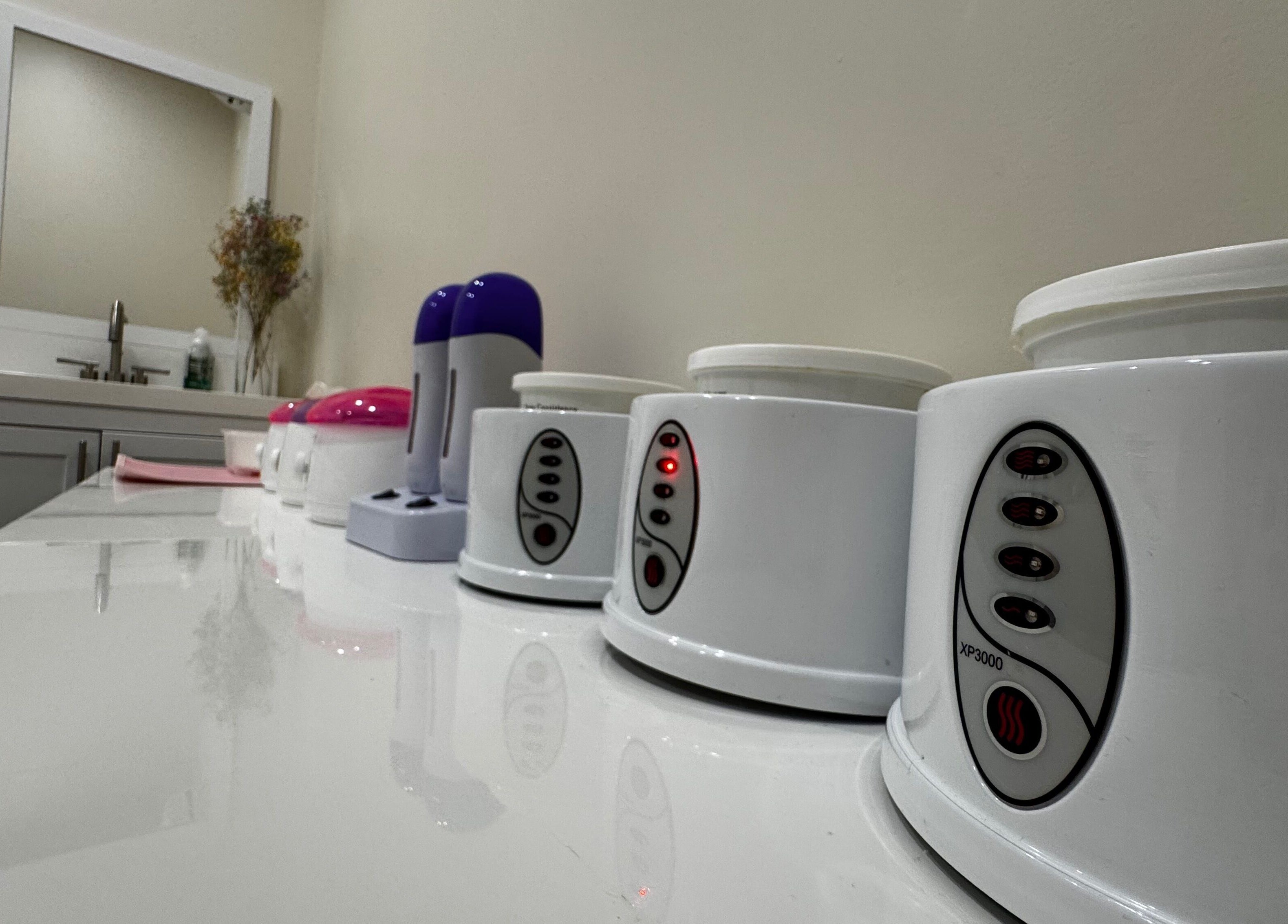 Modern waxing equipment lined up at Sugaring & Waxing by Ervina, Los Angeles, California, US.