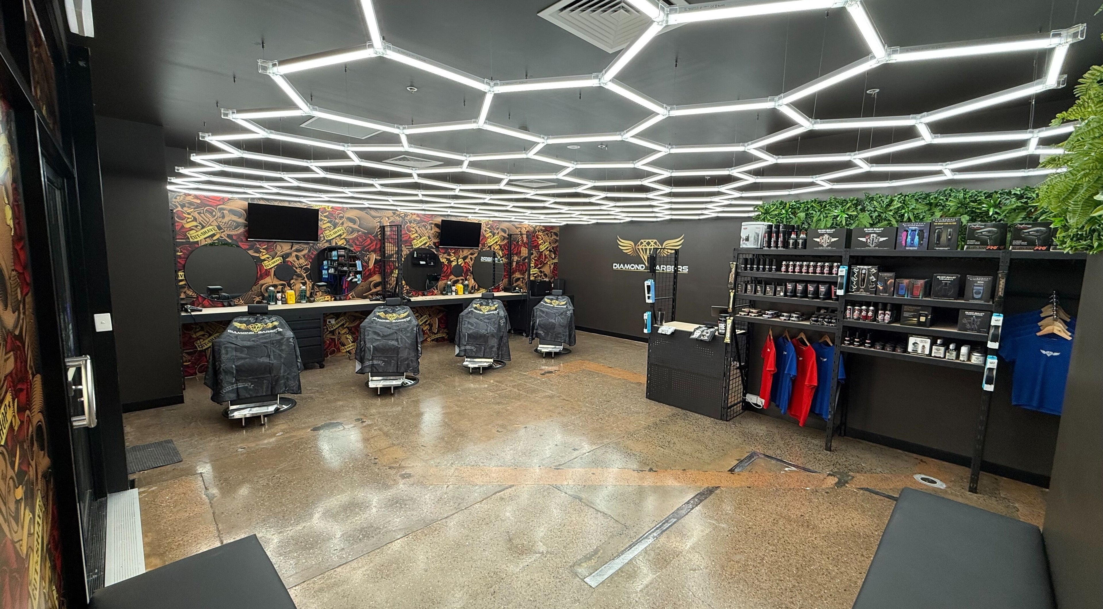 Modern interior of Diamond Barbers - CASUARINA in Casuarina, Northern Territory, AU featuring barber chairs and products.