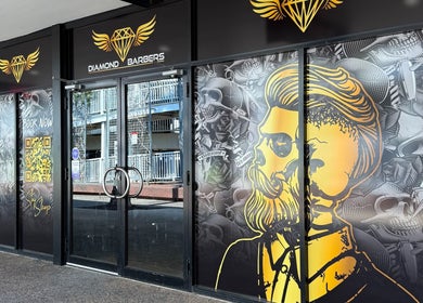 Exterior view of Diamond Barbers - CASUARINA in Casuarina, Northern Territory, AU with artistic wall design.