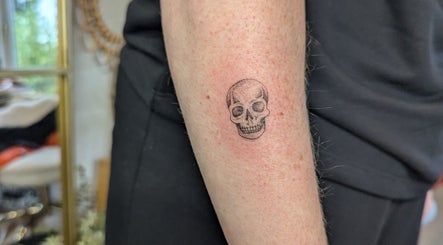 Detailed skull tattoo on forearm at Sarah Harris Tattoos, Bishop's Stortford, England, GB.