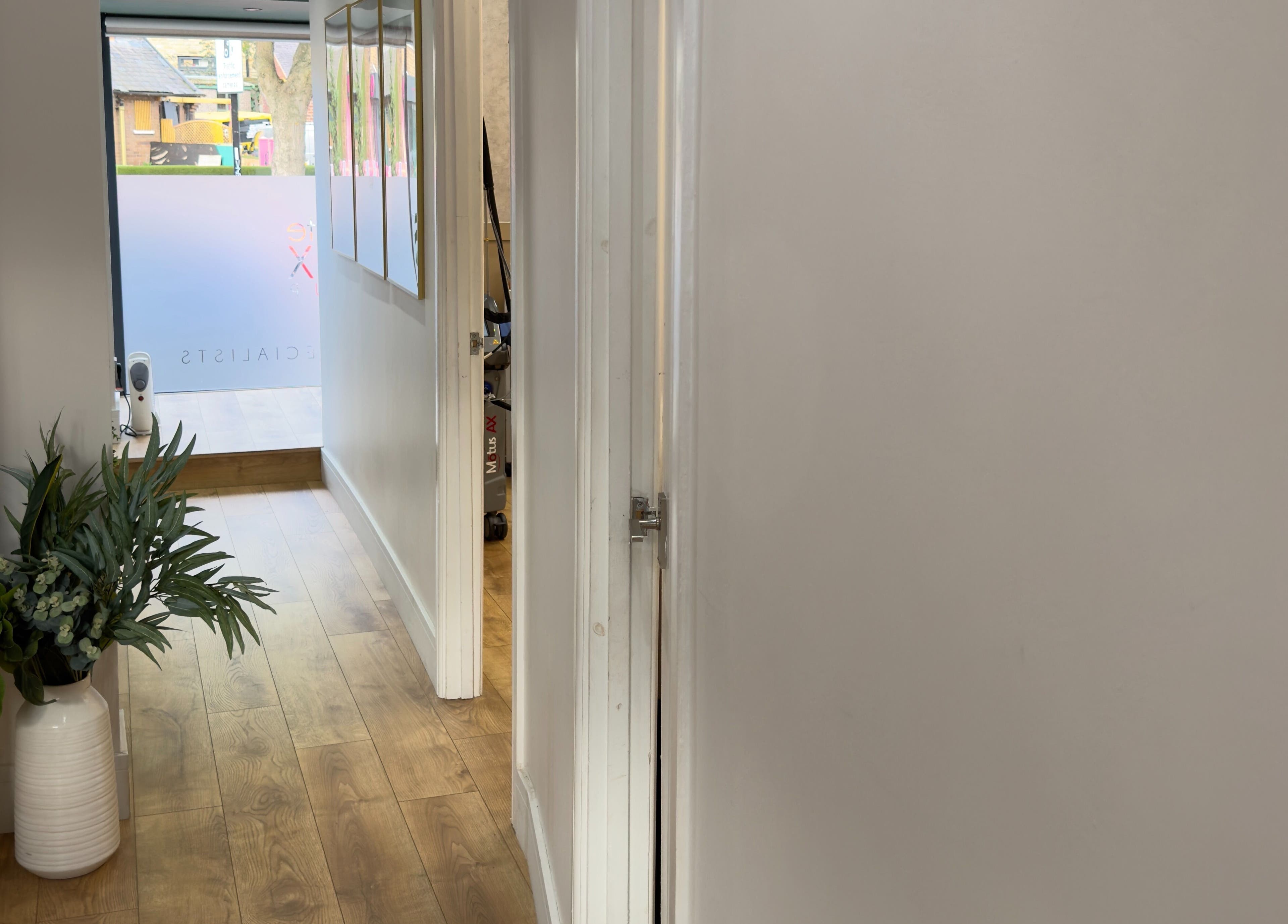 Bright hallway at The Elite Wax Group Sheffield - Abbeydale Road, Sheffield, England, GB with wooden floor and decor.
