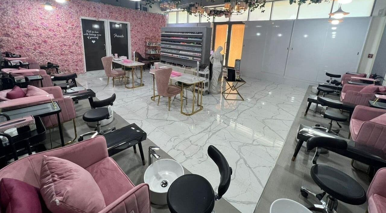 Elegant interior of Nail Atelier Salon in Dubai, Dubai, AE, showcasing plush pink seating and stylish decor.