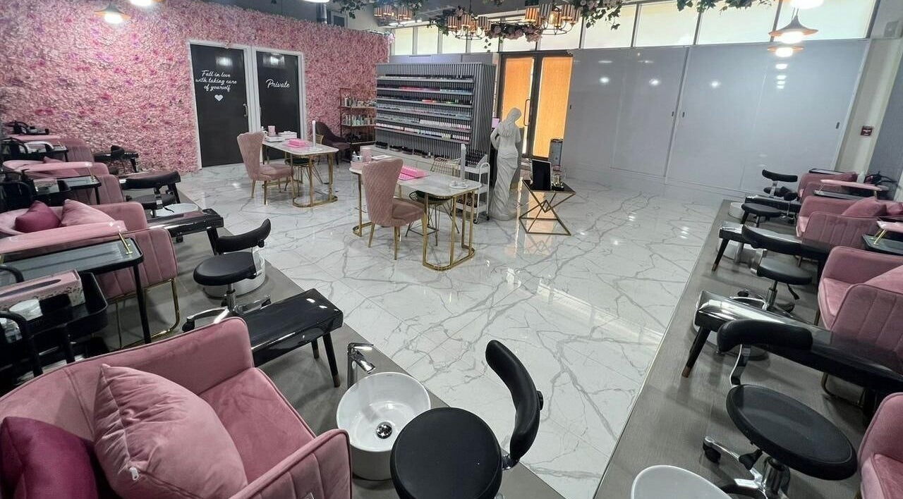Elegant interior of Nail Atelier Salon in Dubai, Dubai, AE, showcasing plush pink seating and stylish decor.