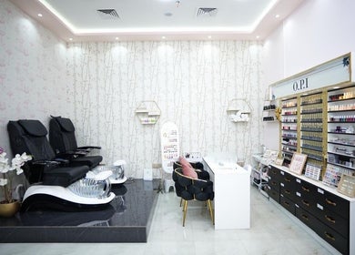 Luxurious nail service area at Dtangle Hair And Beauty Salon, Dubai, Dubai, AE, showcasing modern seating and polishes.