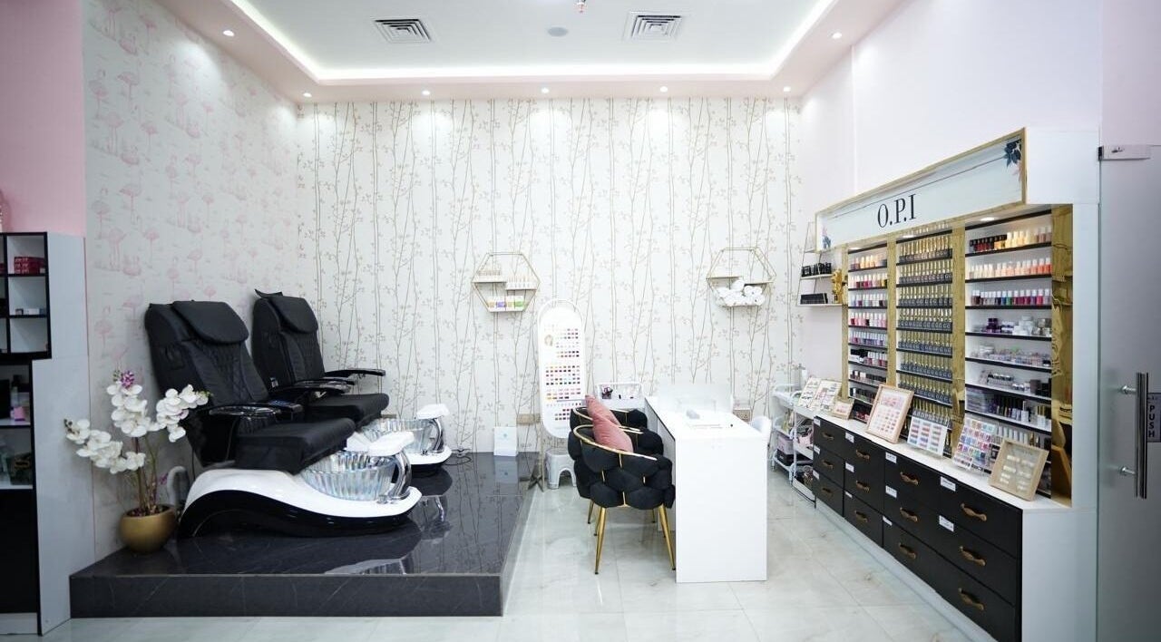 Luxurious nail service area at Dtangle Hair And Beauty Salon, Dubai, Dubai, AE, showcasing modern seating and polishes.