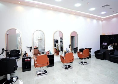 Stylish interior of Dtangle Hair And Beauty Salon in Dubai, Dubai, AE with chic mirrors and seating.