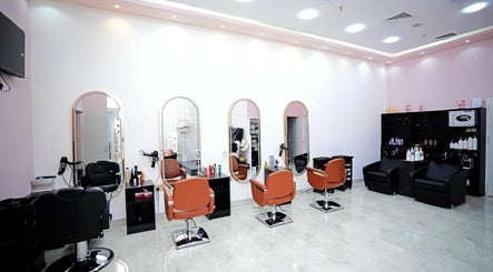 Stylish interior of Dtangle Hair And Beauty Salon in Dubai, Dubai, AE with chic mirrors and seating.