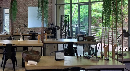 Modern nail salon interior at TLC Nail Bar in Germiston, Gauteng, ZA with sleek workstations and lush greenery.