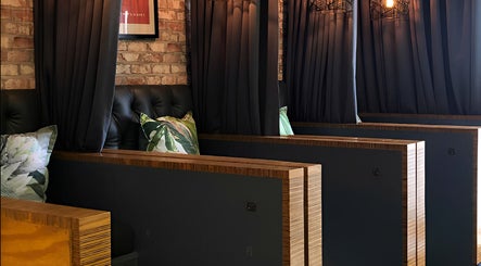 Private, elegant seating in TLC Nail Bar, Germiston, Gauteng, ZA, featuring plush cushions and dark curtains.