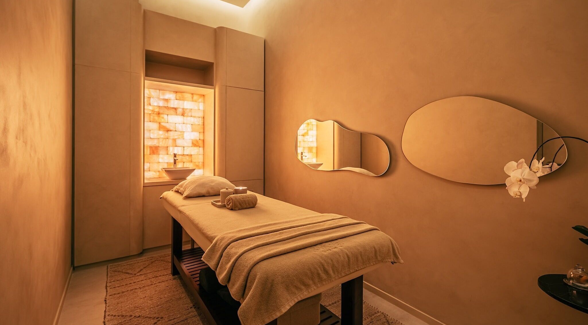 Relaxing treatment room at Saltzen Spa, Dubai, Dubai, AE, with warm lighting and soothing decor.