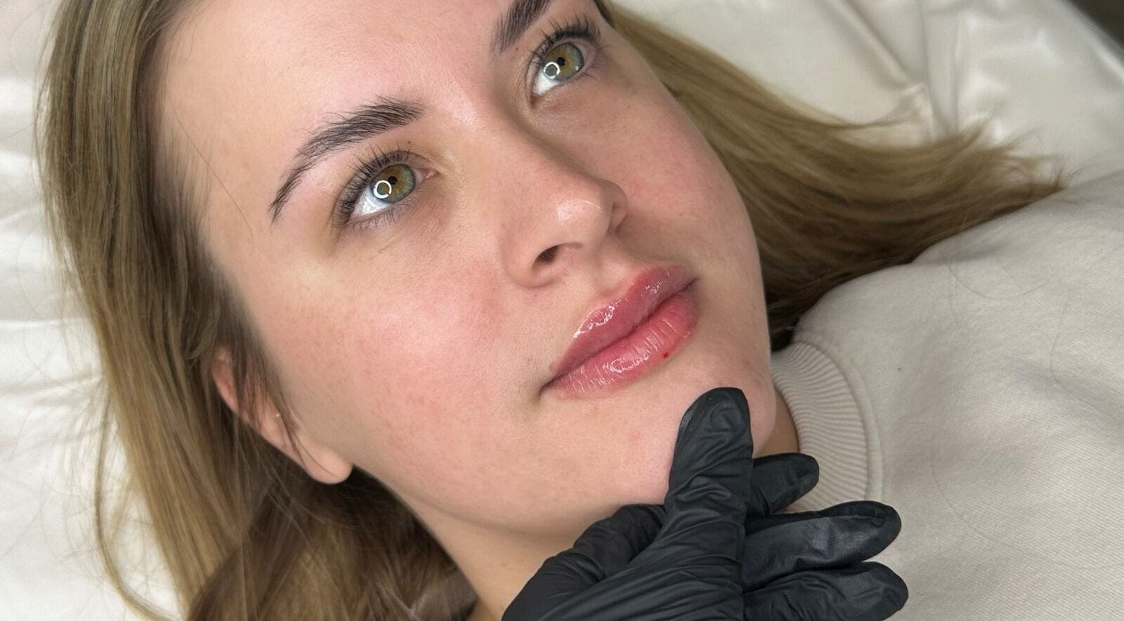 Client at Opulent Aesthetics & Beauty in Stevenage, England, receiving facial treatment for enhanced radiance.